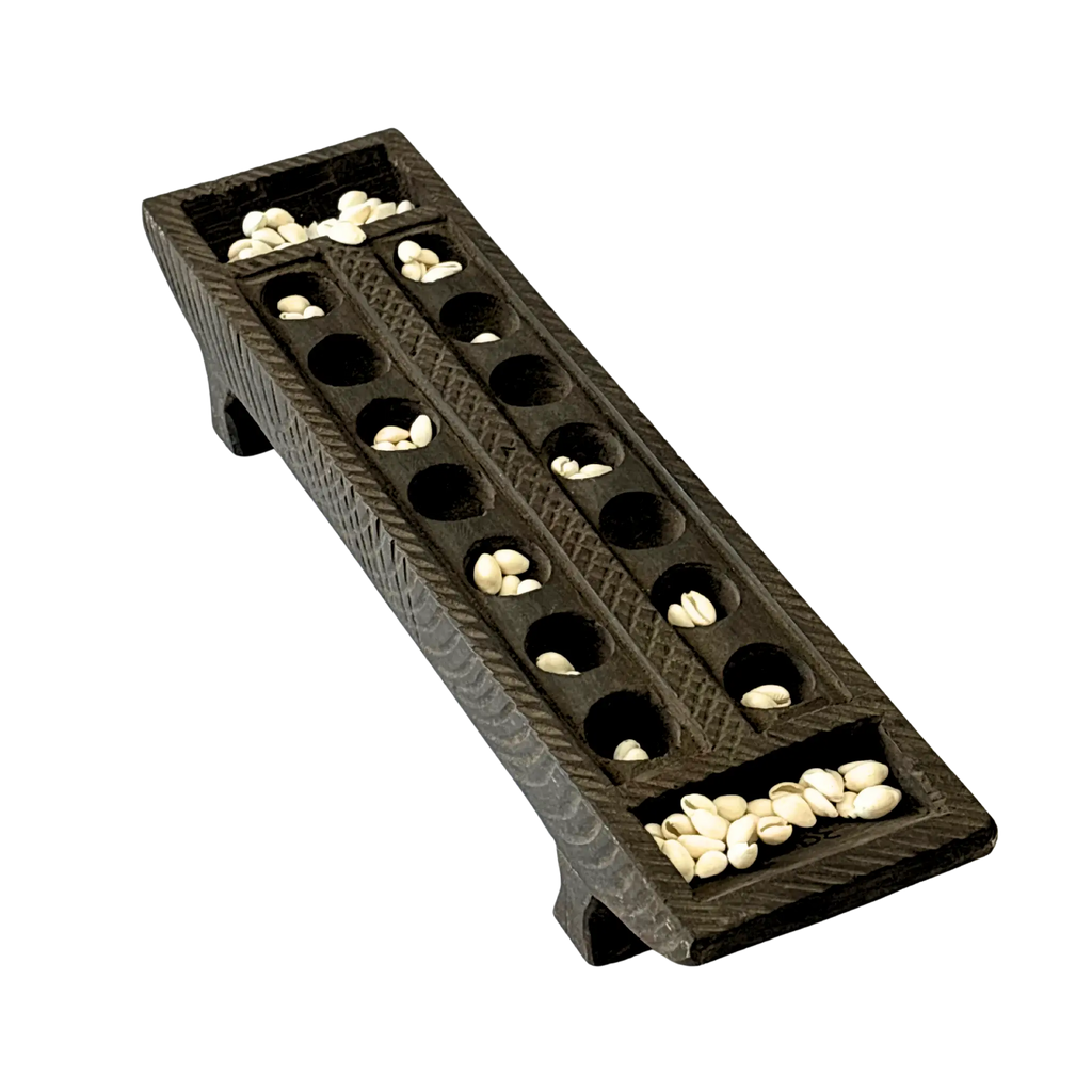 Handcrafted wooden Pallanguzhi board with cowrie shells  traditional South Indian mancala game
