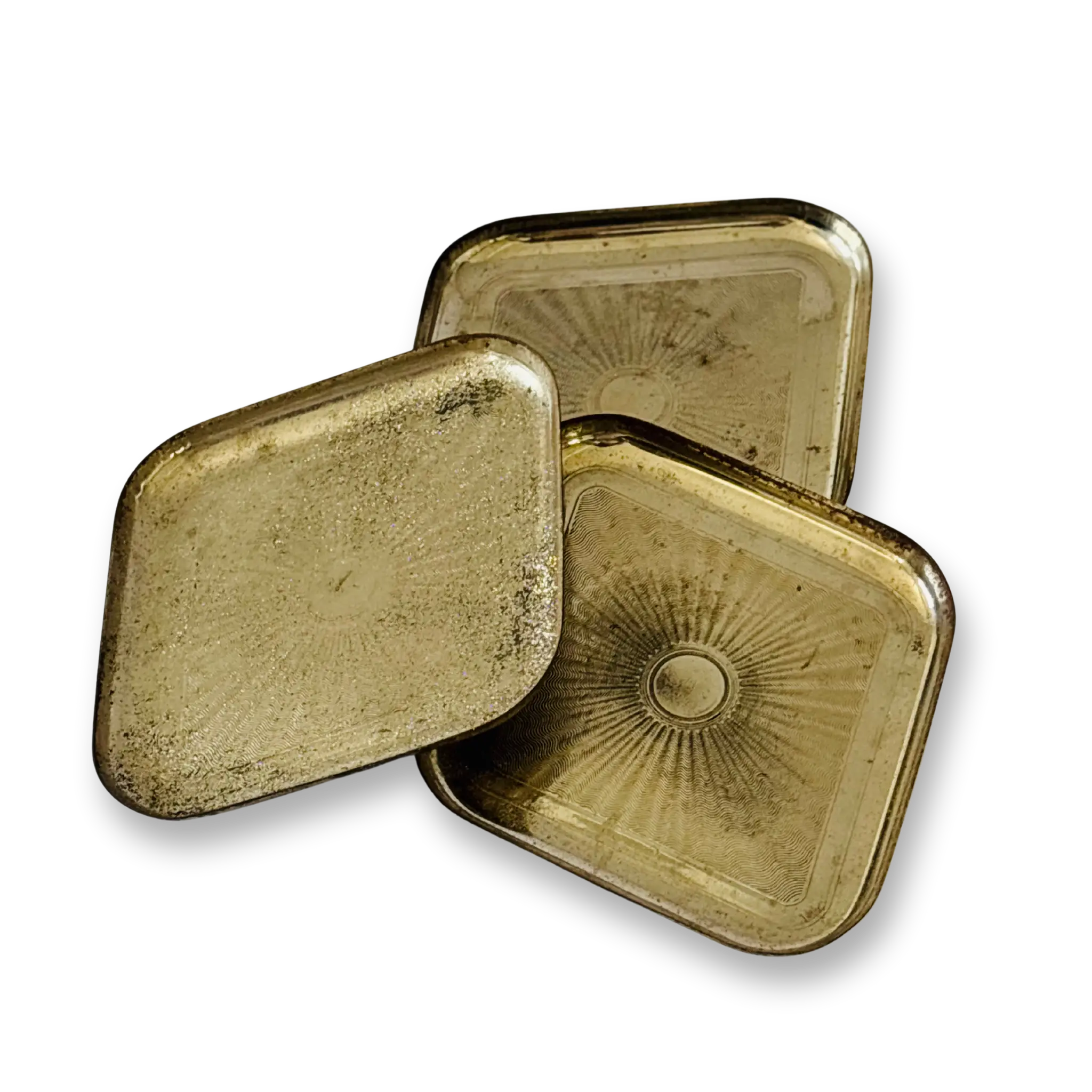 Three Vintage brass trinket platter brass tins with sunburst designs on a white background